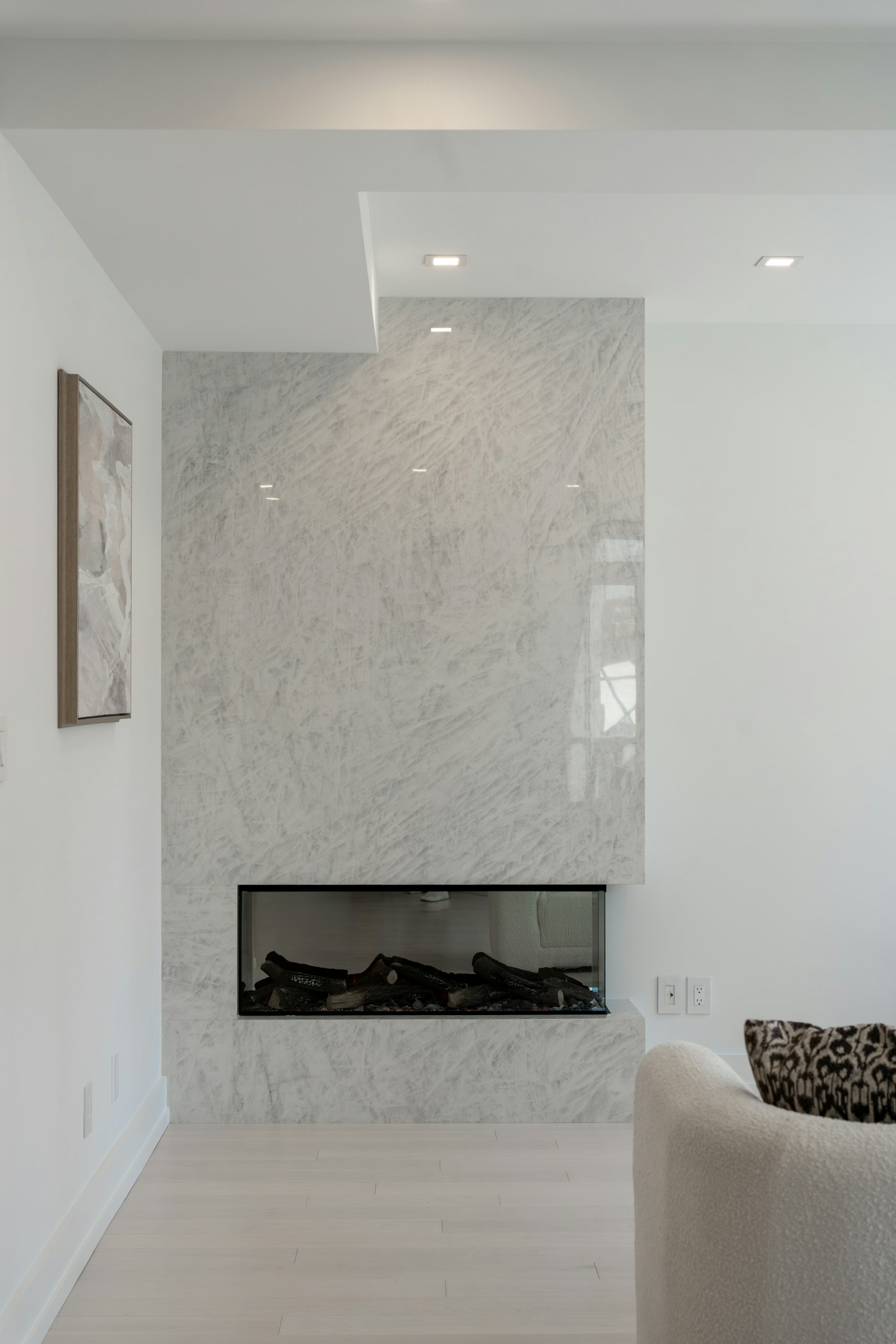 Modern fireplace with white marble surround