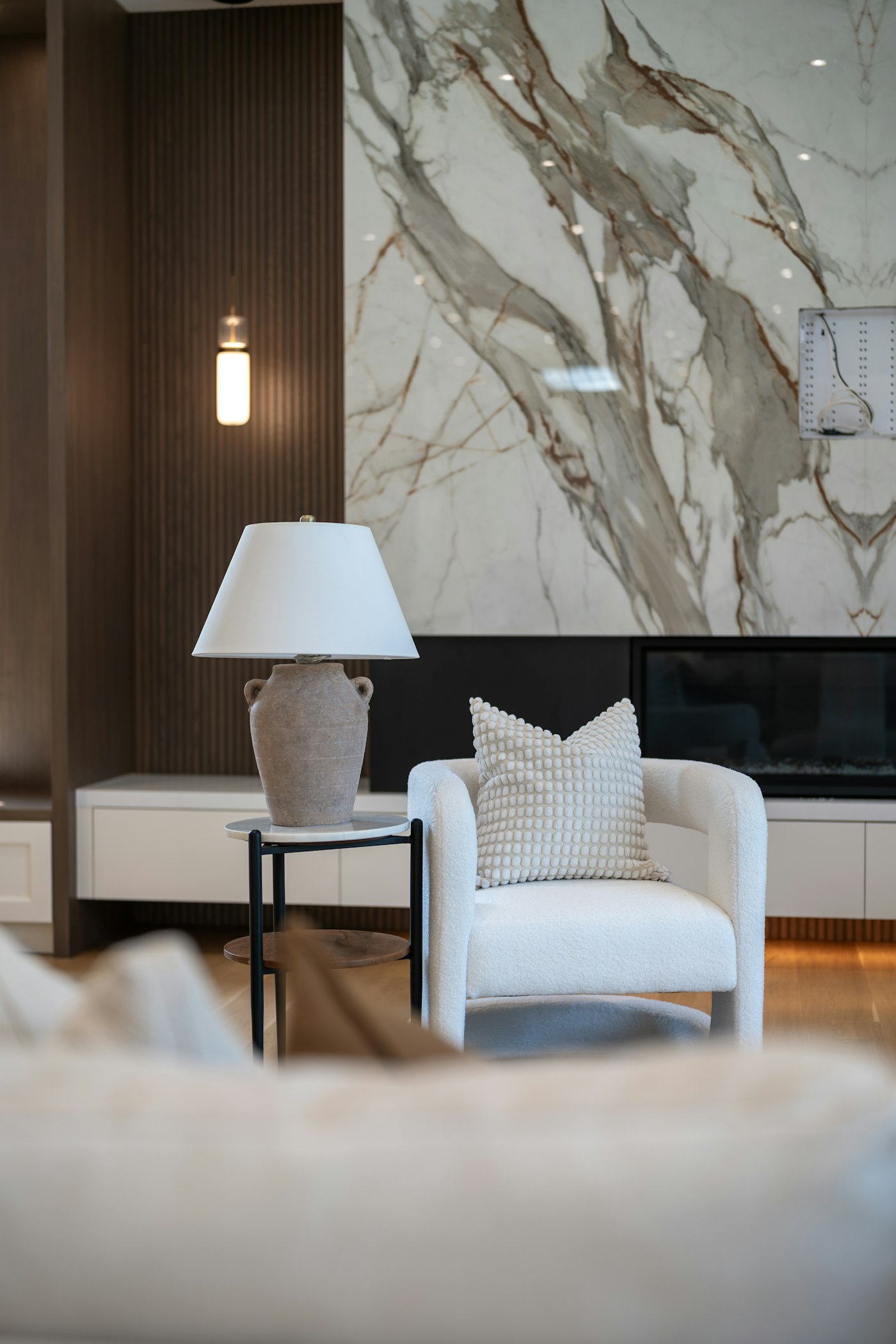 Living room with marble accent wall and fireplace