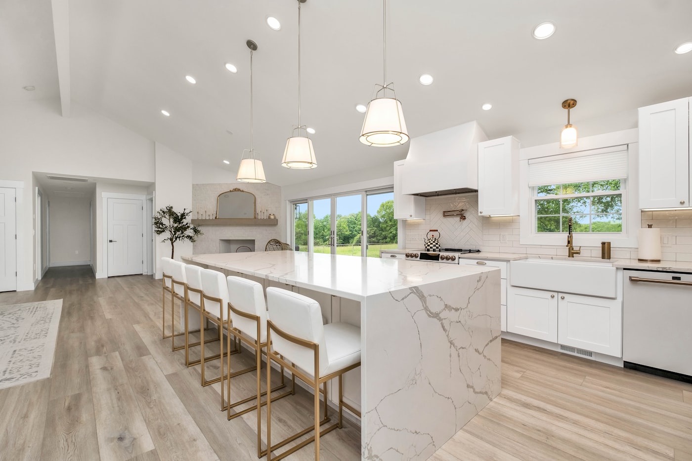 Large kitchen with marble island and white cabinets